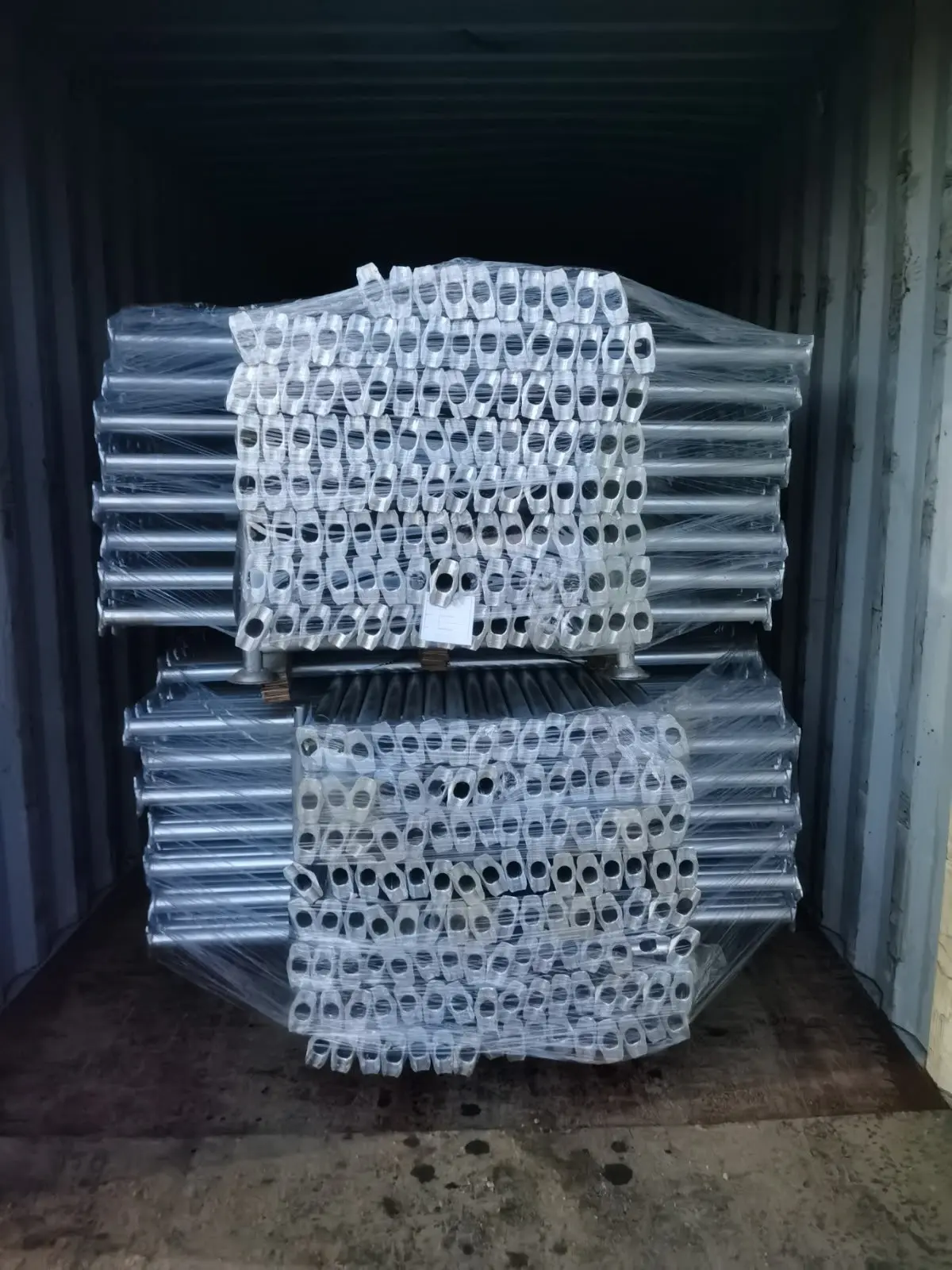 Container loaded with galvanised props