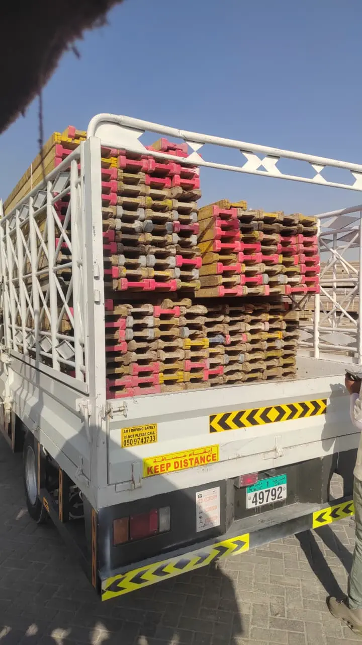 Truck loaded with scaffolding material leaving the yard