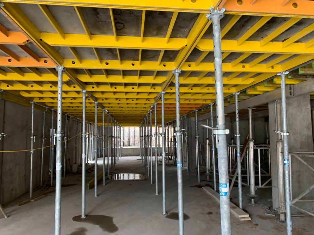 Adjustable steel props under a formwork deck